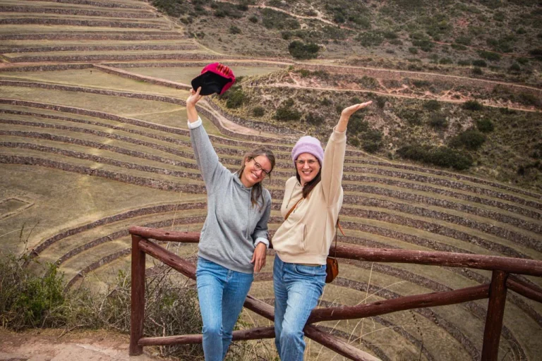 Happy travelers celebrating at the Moray terraces viewpoint during the Maras Moray ATV tour in the Sacred valley of Peru
