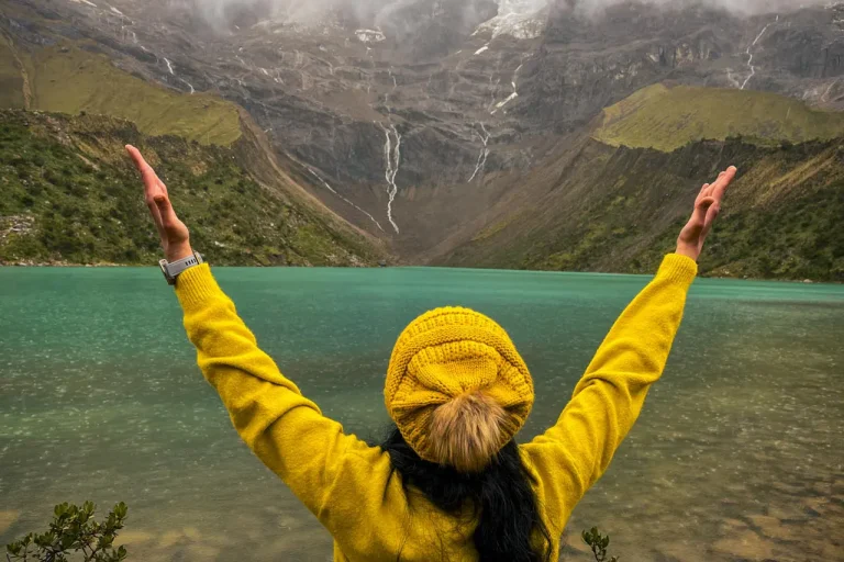 Hiker reaching Humantay Lake after a scenic mountain trek