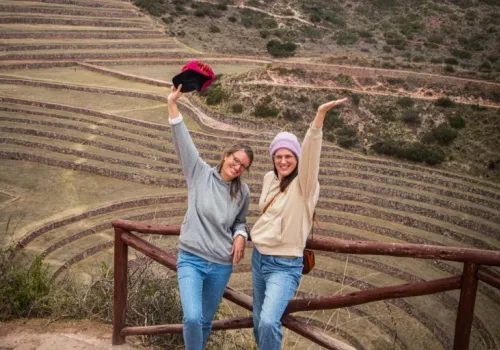 Happy travelers celebrating at the Moray terraces viewpoint during the Maras Moray ATV tour in the Sacred valley of Peru