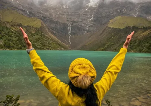 Hiker reaching Humantay Lake after a scenic mountain trek