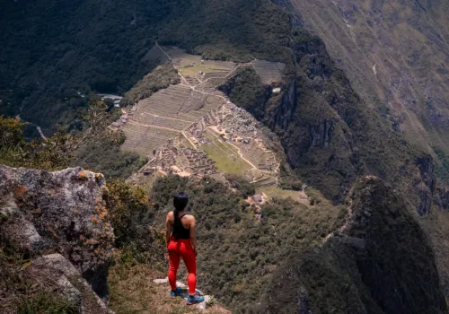 Hiker overlooking terraces from Huayna Picchu