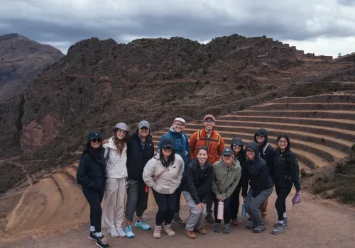 Travelers beside Inca terraces in the Sacred Valley