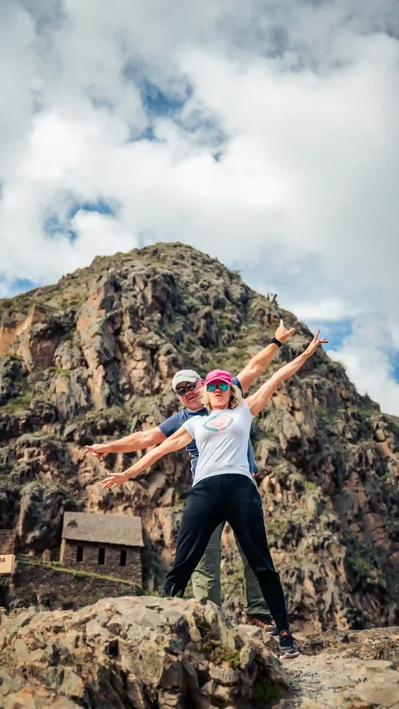 two tourists opening their arms