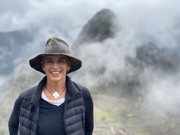 a tourist in machu picchu smiling at the peru guided tours operator