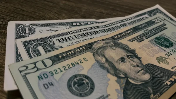 Cinematic shot of US currency bills, highlighting the importance of carrying small denominations for tipping in Peru