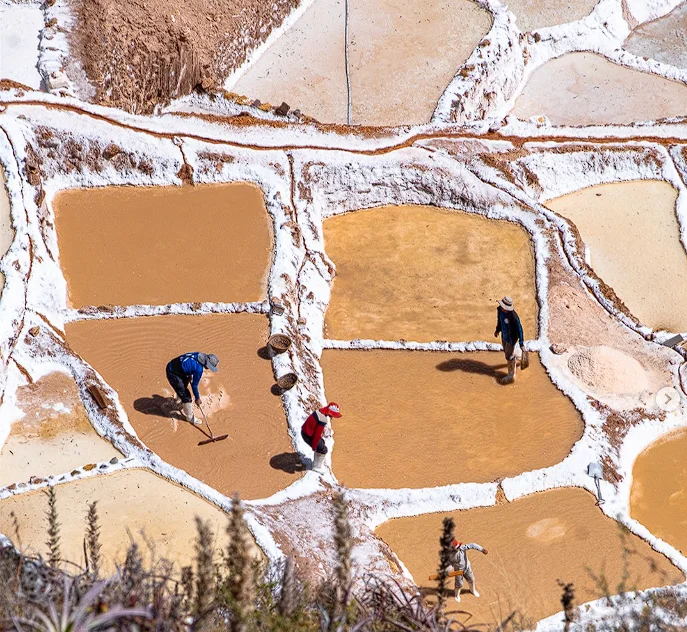 people working in the Maras salt flats