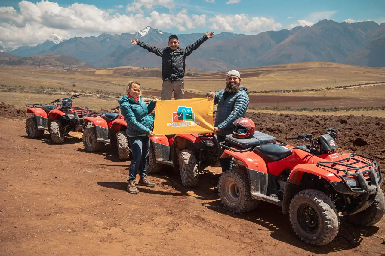 Travelers posing with quad bikes during an ATV maras moray tour in the sacred valley